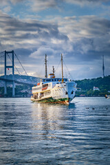 Istanbul, A ferry sails along the Bosphorus in the Besiktas area near the Ortakoy pier