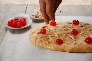 Woman preparing St John's cake.
