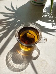 tea in a transparent mug, brewed tea. tea ceremony. morning tea. mug of tea on the kitchen table