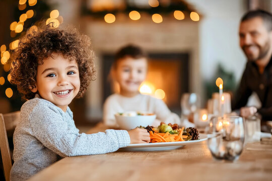 Latino children having dinner with their father in a living room decorated with lights. Concept of Christmas, celebrations and single parent families.