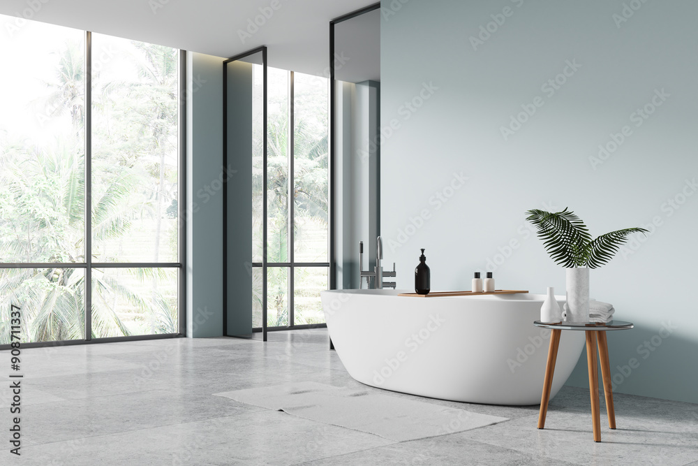 Wall mural blue hotel bathroom interior with tub and glass partition, panoramic window