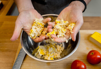 Chef at the kitchen preparing tofu scramble with vegetables