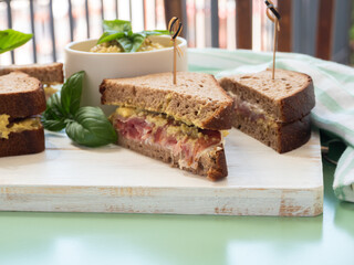 Rye bread sandwich with italian ham and avocado cashew spread