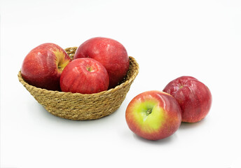 Fresh Red Star apples (Malus domestica 'Redstar') in a basket, isolated on white background
