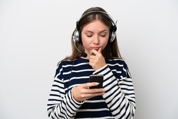 Telemarketer caucasian woman working with a headset isolated on white background thinking and sending a message