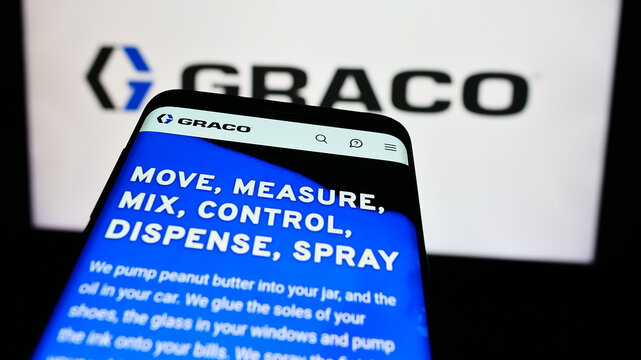 Stuttgart, Germany - 07-24-2024: Mobile phone with website of US fluid-handling equipment company Graco Inc. in front of business logo. Focus on top-left of phone display.