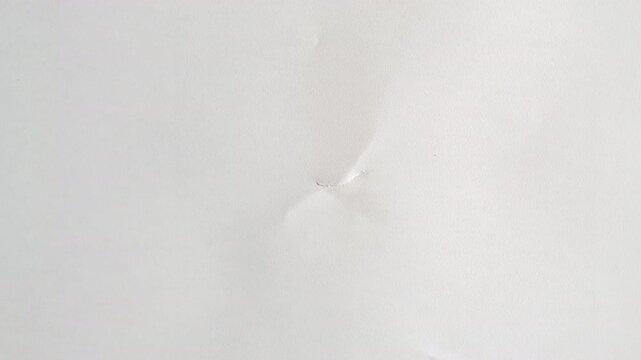 A full screen paper burst with a hole tearing from the middle in a stop motion style.