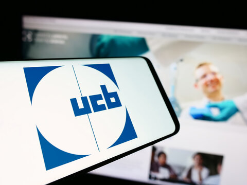 Stuttgart, Germany - 07-25-2024: Cellphone with logo of Belgian biopharmaceutical company UCB SA in front of business website. Focus on center-left of phone display.
