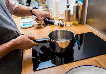 Chef at the kitchen preparing healthy quinoa bowl with avocado