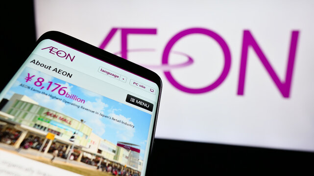 Stuttgart, Germany - 07-29-2024: Mobile phone with website of Japanese retail holding company Aeon Co. Ltd. in front of business logo. Focus on top-left of phone display.