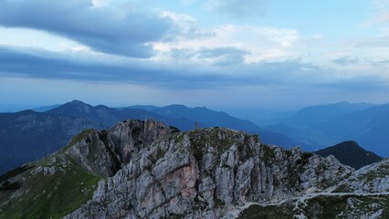 Tiny human on mountain ridge in the evening