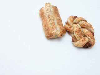 freshly baked sweet roll buns or bread rolls, golden brown soft breakfast or tea time snack isolated white background, taken from above