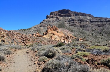 Scenic view of volcanic rock formations in desert during sunny day, Teide National Park, Tenerife