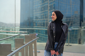 Young muslim woman with hijab in a modern city