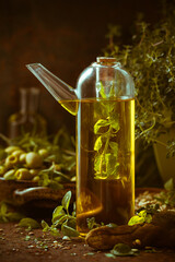 A bottle olive oil fruits branches herbs