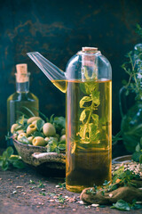 A bottle olive oil fruits branches herbs