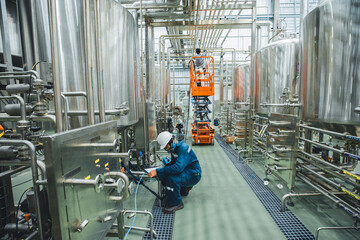 Male work visual draft inspection process stainless steel tanks and in equipment tank facility for beer drinks cellar at the with vertical stainless