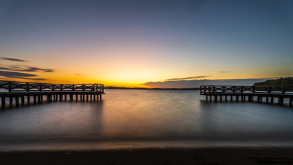 Obraz premium Summer vacation at the lake. Sunset in Masuria. Pier at sunset