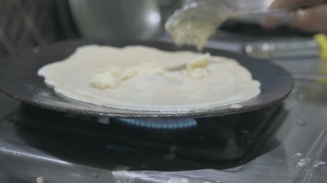 Patishapta Pitha, a famous Bengali Dessert Recipe, being prepared during Winter season. Patishapta is a type of pithe made in celebratory occasions, quick Indian dessert. Howrah, West Bengal, India