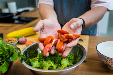 Chef at the kitchen preparing spicy glass noodle salad