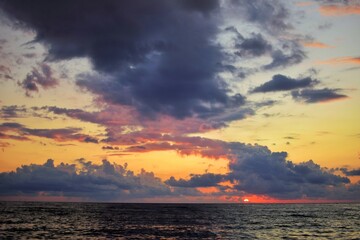 View of the sea in the evening. Sunset sky with beautiful clouds.