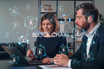 Blockchain concept with business professionals working on a laptop.