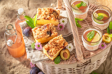 Tasty and sweet plum yeast cake served on beach.