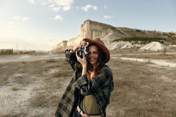 Woman capturing stunning mountain and rock formation scenery with her camera