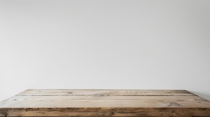 White wood table with plain white wall, ideal for showcasing products