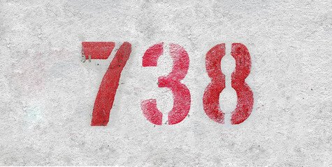 Red Number 738 on the white wall. Spray paint.