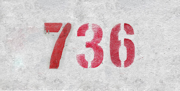 Red Number 736 on the white wall. Spray paint.