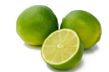 whole and half with slice of fresh green lime isolated on white background