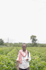 Indian farmer holding spray pump in hand