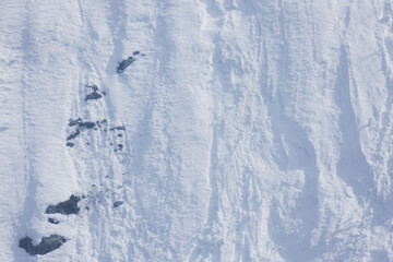 Background of steep mountain slope covered with snow. Avalanche danger