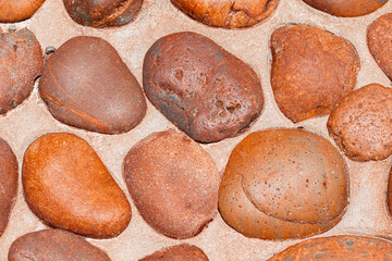 Top view. The surface of the convex round stone is brown. For floor and background.
