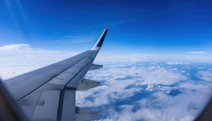 Fototapeta premium Airplane fly high in sky on a sunny day, view from plane window of beautiful island and sea and clouds and wing turbines