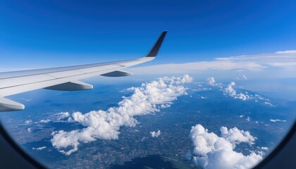 Airplane fly high in sky on a sunny day, view from plane window of beautiful island and sea and clouds and wing turbines