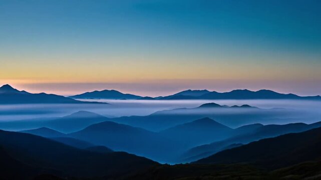 Wide shot of a mountain range at dawn, mist rising, breathtaking view
