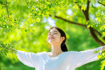 woman nature in a park, with a beautiful sunlight and green trees in the background. feeling happy while relaxing outdoors on a summer day, with a smiling face expression of relaxation and happiness