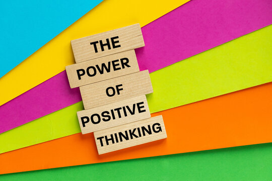 Symbol of positive thinking. Beautifully colored background with words on wooden blocks. Conceptual slogan, motivating message of positive mindset. Copy space.