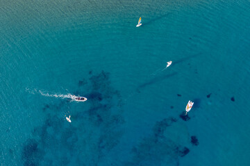Obraz premium Drone aerial of docked boats and motor speed boat in the turquoise water of Cyprus