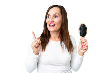 Middle age woman with hair comb over isolated chroma key background intending to realizes the solution while lifting a finger up