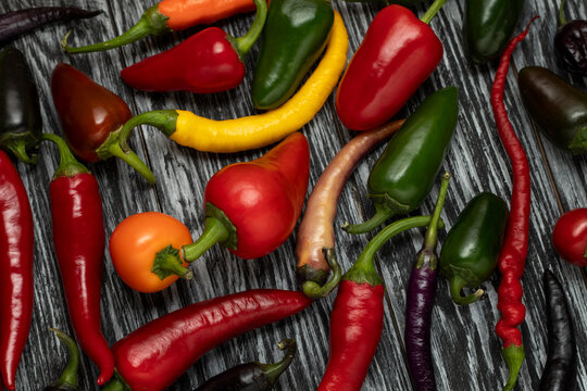 Mix of hot cayenne peppers, jalape&ntilde;os and buena mulata on the table. Top view.