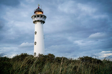 Netherlands. Egmond aan Zee.  Van Speijk Lighthouse with blue sky and clouds and burning light