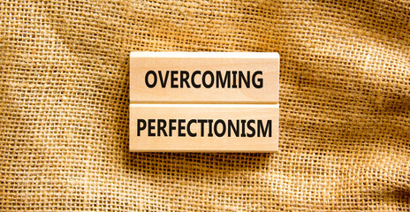 Overcoming perfectionism symbol. Concept words Overcoming perfectionism on beautiful wooden block. Beautiful canvas background. Business Overcoming perfectionism concept. Copy space.