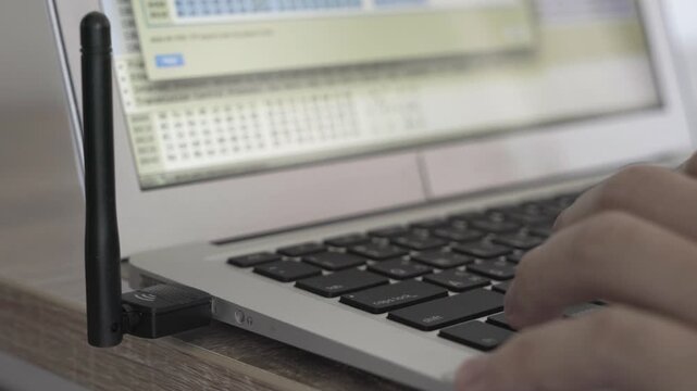 A laptop screen shows a lot of numbers and letters. The laptop is open to a page with a lot of information