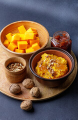 Traditional Sweet Gourd Porridge Served With Fresh Fruits and Nuts on a Wooden Platter