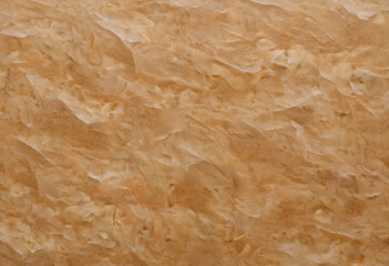 A textured background featuring crumpled, wrinkled paper in warm beige tones. The surface has a natural, organic feel, ideal for artistic or design purposes.