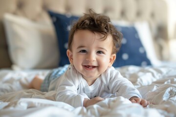 Fototapeta premium Happy Baby Boy Lying on Bed