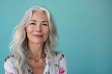 Fototapeta premium Portrait of Happy Smiling attractive mature woman on colored background with copy space, banner template